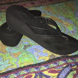 Black thong sandals with a 2” wedge